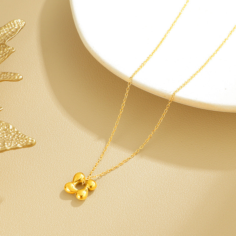 Damen Halskette mit stilisiertem Blumendesign und glänzendem Anhänger Shop Nory