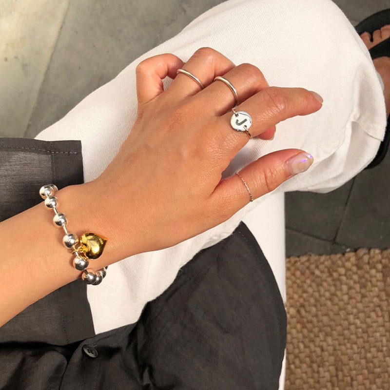 Damenarmband mit herzförmigem Anhänger und eleganten Perlen Shop Nory