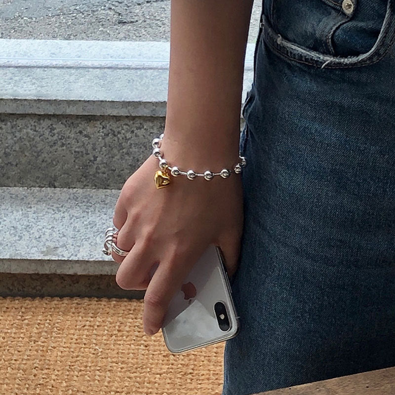 Damenarmband mit herzförmigem Anhänger und eleganten Perlen Shop Nory