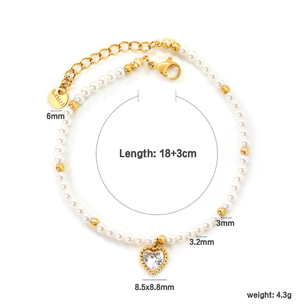 Damen Armband mit schimmernden goldenen Perlen und funkelndem Herzanhänger Shop Nory