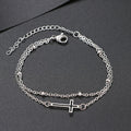 Damen Armband mit filigranem Kreuzdesign und elegantem Kettenspiel Shop Nory