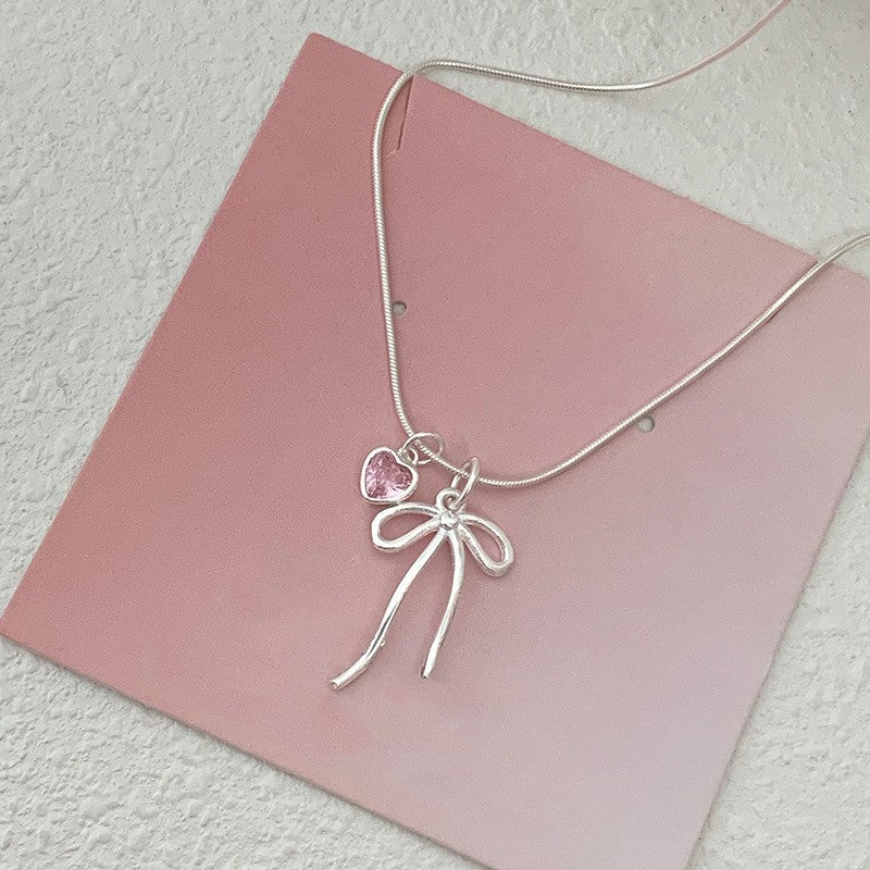 Damen Halskette mit elegantem Schleifenanhänger und herzförmigem Kristall Shop Nory