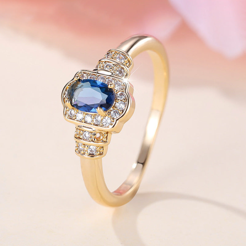 Damenring mit ovalem blauem Edelstein und funkelnden Zirkonia-Steinen Shop Nory