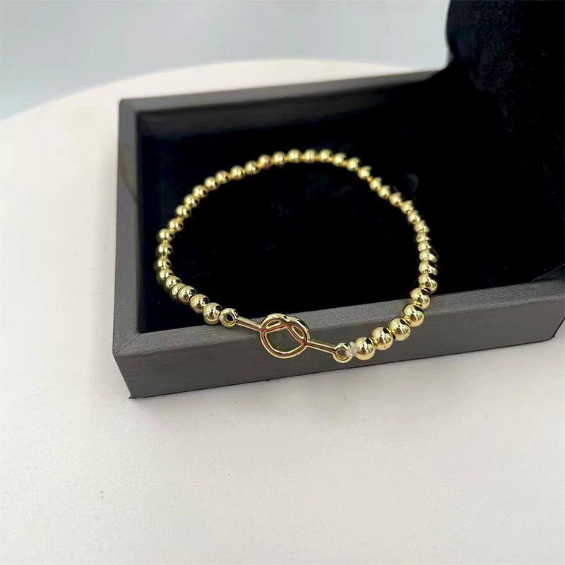 Damen Armband aus feinen, goldfarbenen Kugelperlen Shop Nory