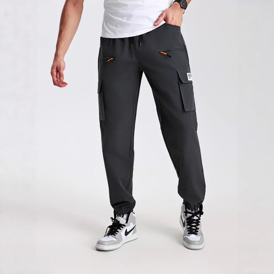 Herren konisch geschnittene Utility-Cargohose im Joggerstil mit Tunnelzugbund, Reißverschlusstaschen & elastischen Beinabschlüssen Shop Nory