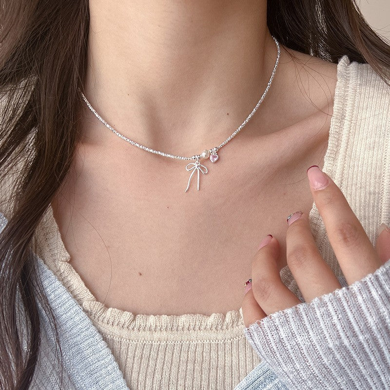 Damen Armreif mit Herz-, Perlen- und Schleifenanhänger Shop Nory