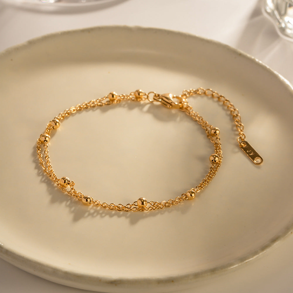 Damen Armband mit filigranem Kettendesign und glitzernden Perlen Shop Nory