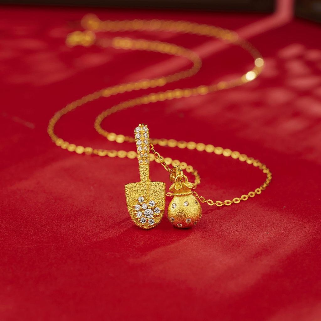 Damen Halskette mit goldfarbenem Schaufel- und Geldbeutel-Anhänger und funkelnden Kristallen Shop Nory