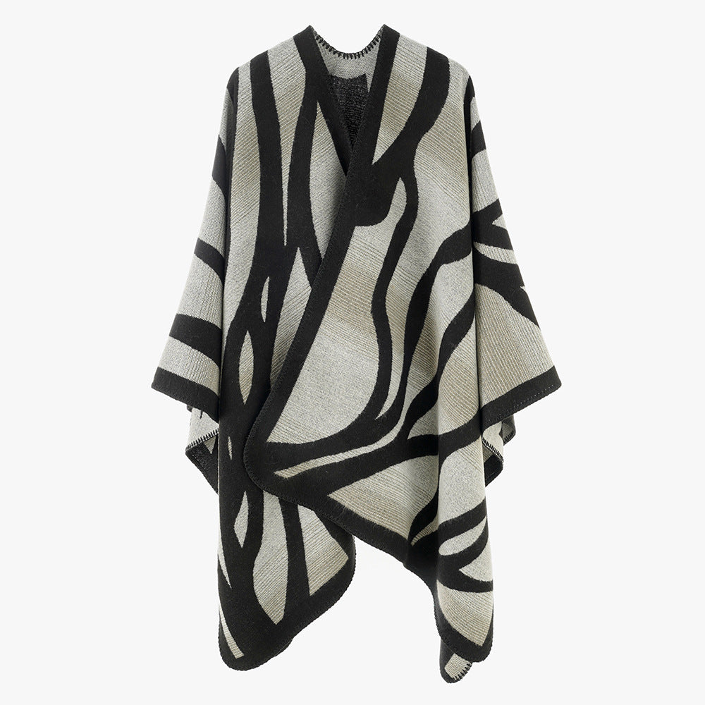 Damen Oversize-Strickcape mit abstrakter Wellenjacquard‑Struktur und kontrastierter Kettelkante Shop Nory