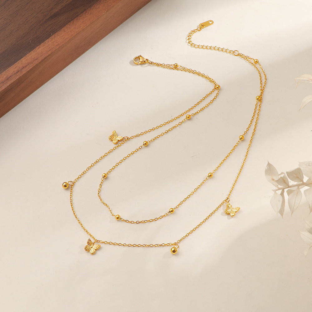 Damen mehrlagige Halskette mit filigranen Schmetterlings- und Kugeldetails Shop Nory