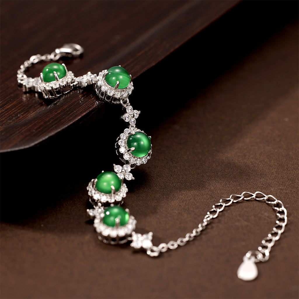 Damen Armband mit funkelnden Kristallen und grünem Edelstein Shop Nory