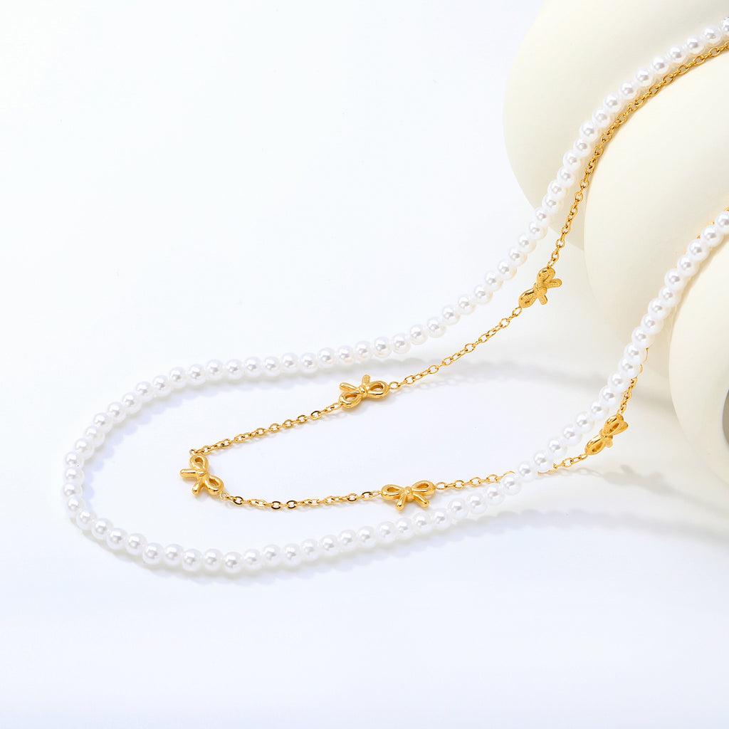 Damen mehrlagige Halskette mit zarten Perlen und eleganten Schleifenanhängern Shop Nory