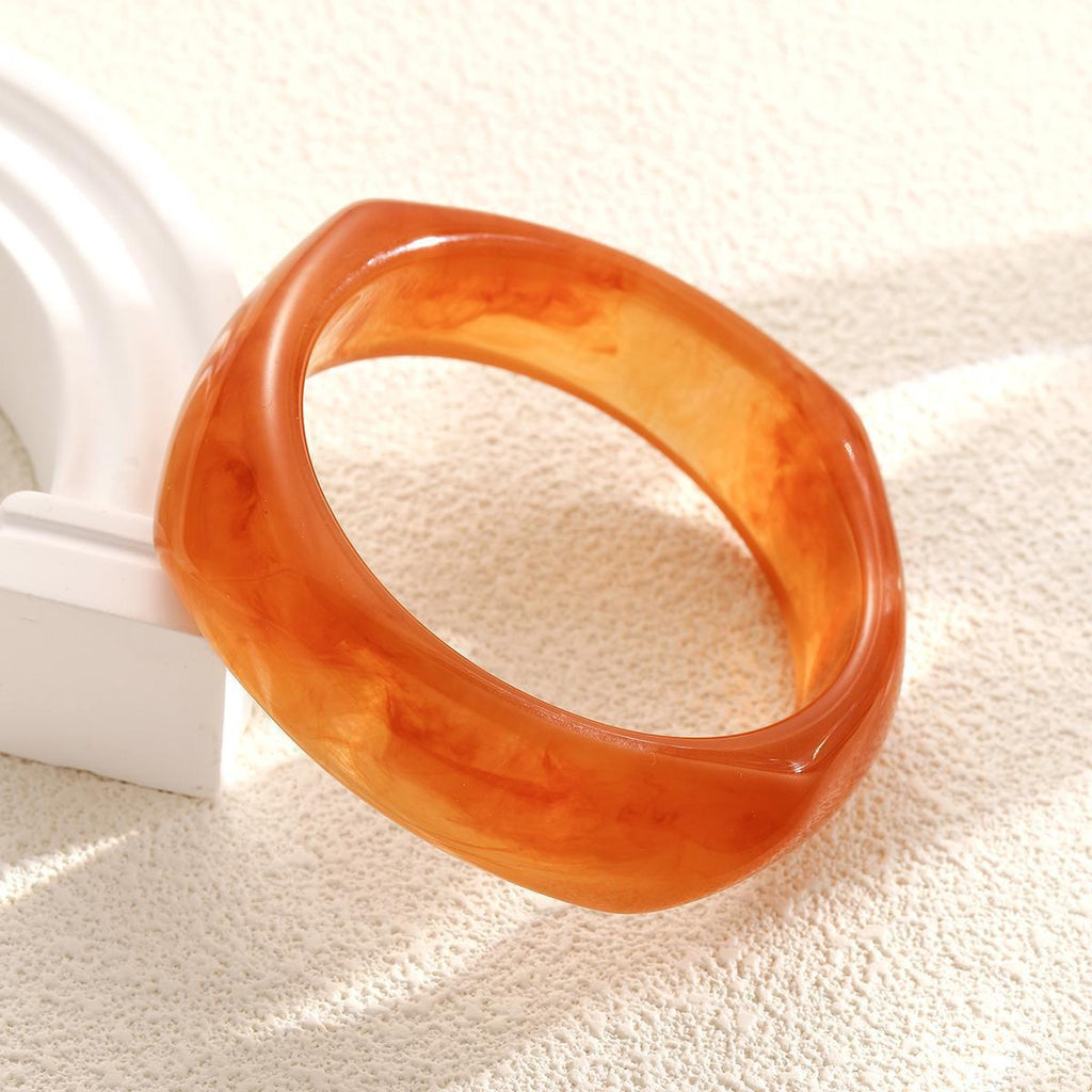 Damenarmreif aus hochwertigem Acryl mit eleganter, geschwungener Form Shop Nory
