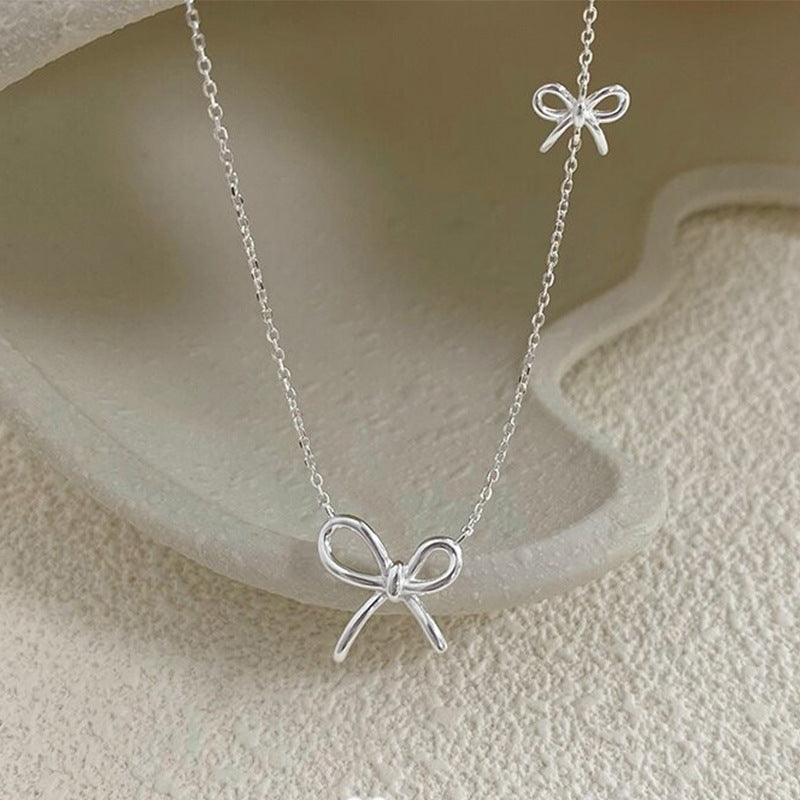 Damen Silberne Halskette mit stilvollem Schleifen-Design Shop Nory