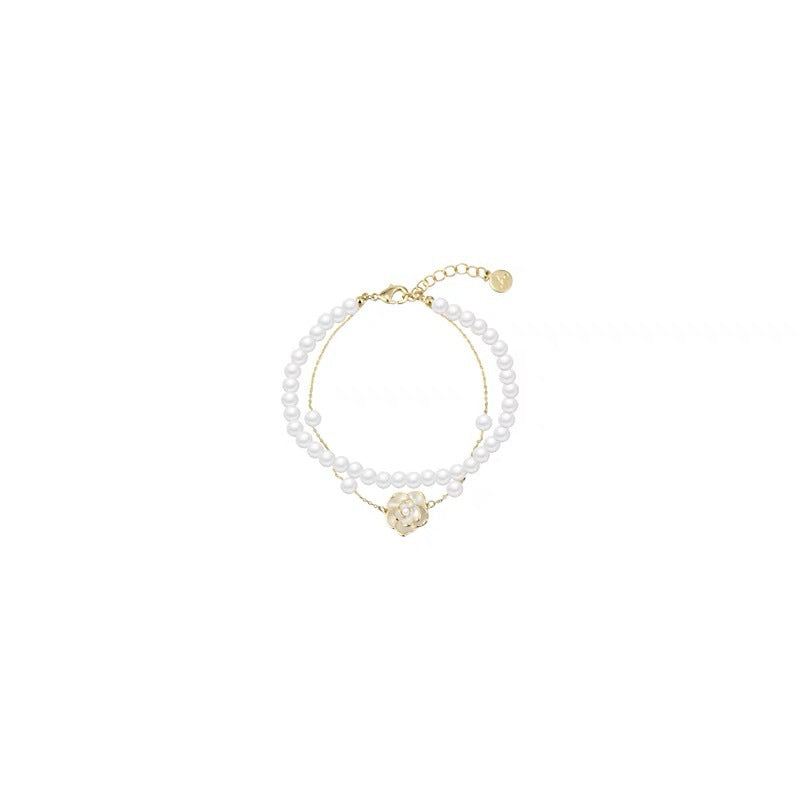 Damen Armband mit zarter Perlenverzierung und eleganter Rosenapplikation Shop Nory