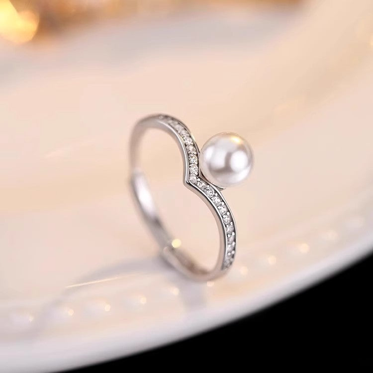 Damen Ring mit modernem geschwungenem Design und Perlenakzent Shop Nory