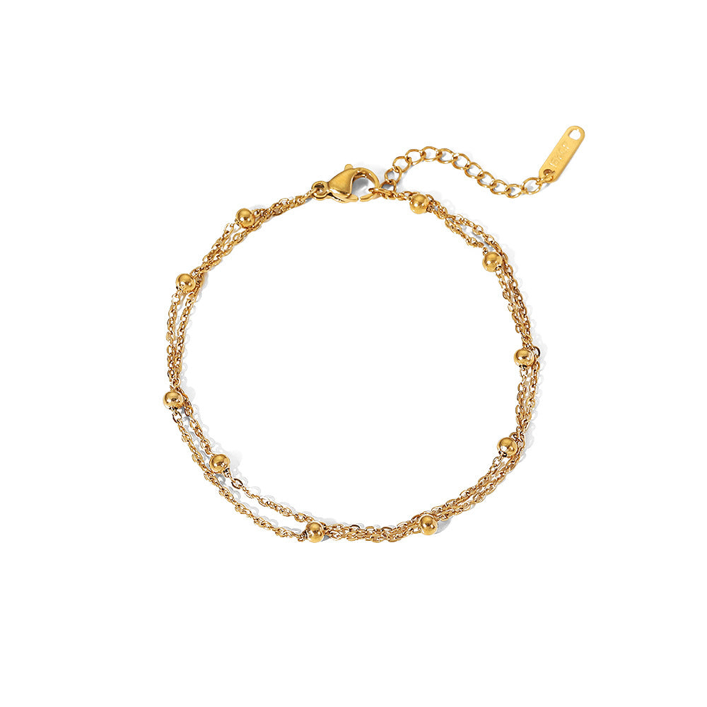 Damen Armband mit filigranem Kettendesign und glitzernden Perlen Shop Nory