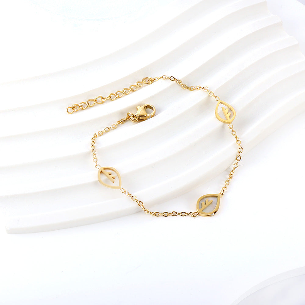 Damen Armband mit feinen Blattmotiven aus Edelstahl und goldplattierter Oberfläche Shop Nory
