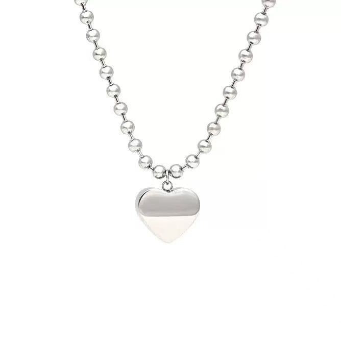 Damen Halskette mit glänzendem Herzanhänger und edlem Perlen-Design Shop Nory