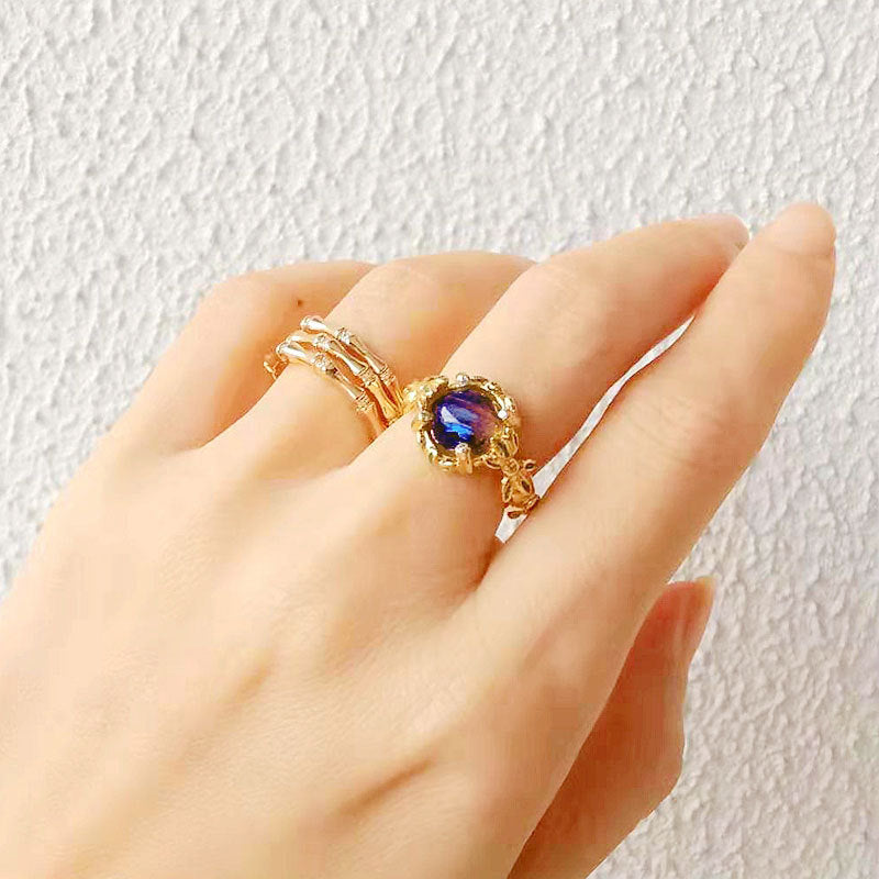 Damenring mit kunstvollem Blumendesign und violettem Edelstein Shop Nory