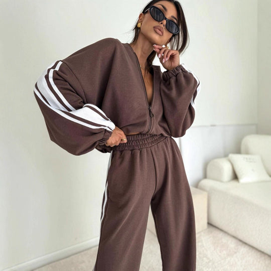Damen cropped Zip-Hoodie mit voluminösen Ballonärmeln und High-Waist Relaxhose im sportlichen Seitenstreifen-Design Shop Nory