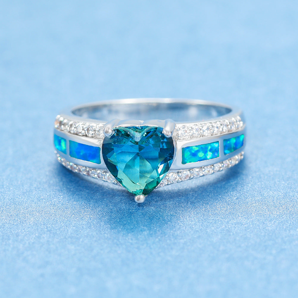 Damen Ring mit herzförmigem smaragdgrünem Stein und feinen Zirkonia-Details Shop Nory