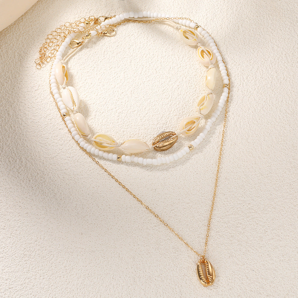 Damen mehrlagige Muschelkette mit goldenen Akzenten Shop Nory