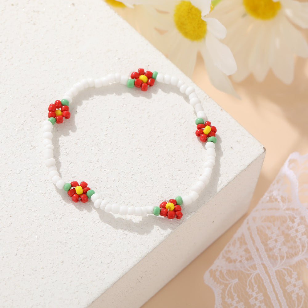 Damen modisches und verspieltes Perlenarmband mit floralem Akzent Shop Nory