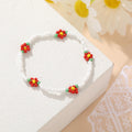 Damen modisches und verspieltes Perlenarmband mit floralem Akzent Shop Nory