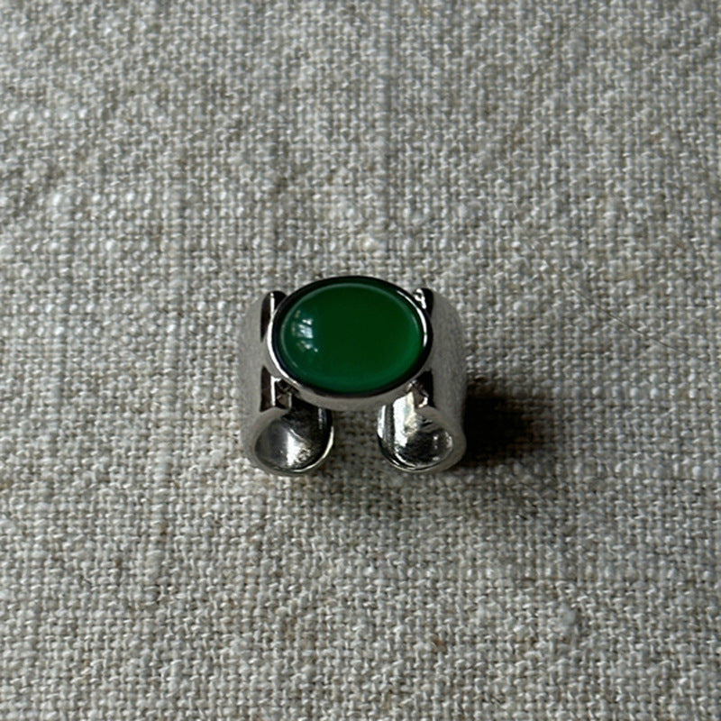 Damenring mit elegantem, geschwungenem Design und grünem Stein Shop Nory