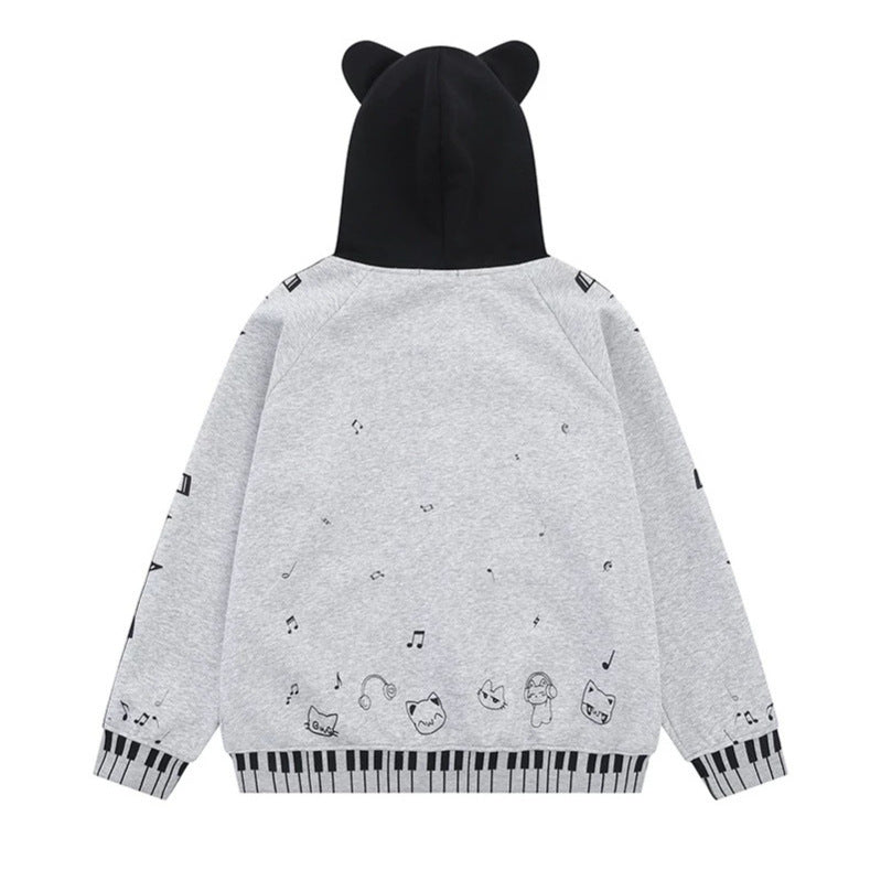 Damen Kapuzensweatjacke mit durchgehendem Reißverschluss, Musikprint, Klaviertasten‑Bündchen und Ohrenkapuze Shop Nory