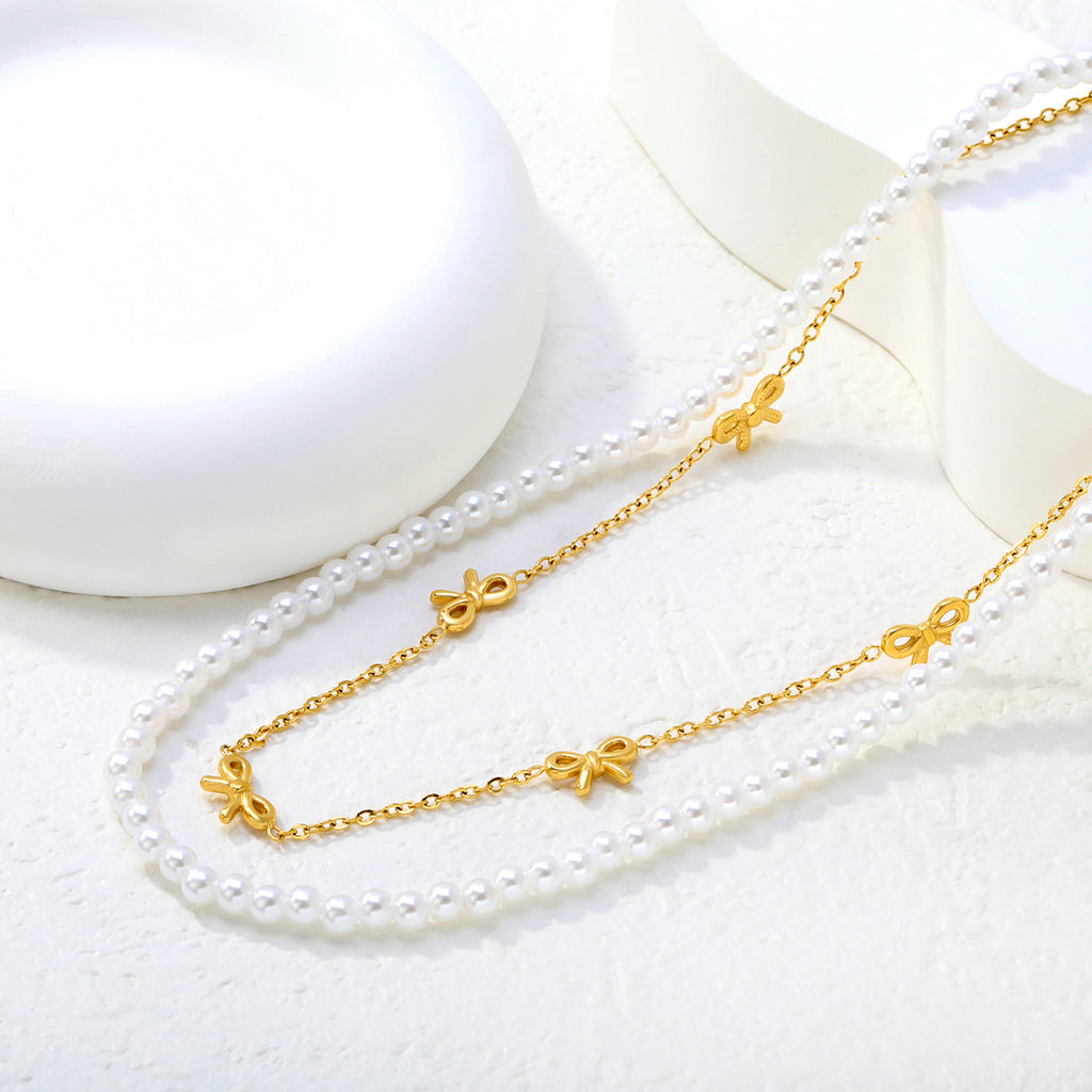 Damen mehrlagige Halskette mit zarten Perlen und eleganten Schleifenanhängern Shop Nory