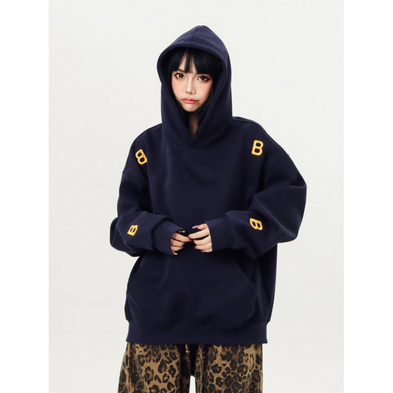 Unisex Oversized Kapuzenpullover mit großflächigem Intarsien‑Blockprint und geripptem Saum Shop Nory