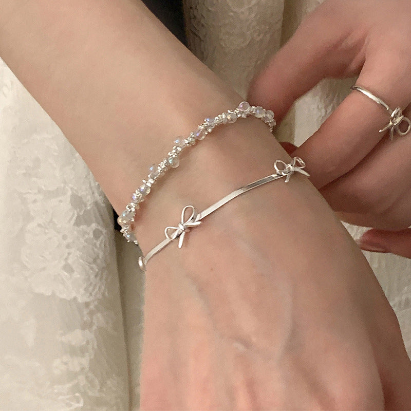 Damen Halskette mit geschwungenem Design und zartem Schleifenanhänger Shop Nory