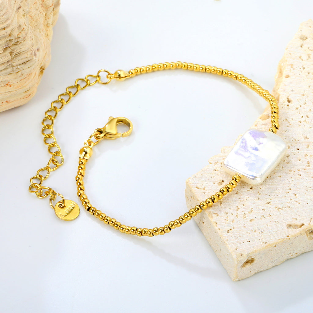 Damen Armband mit modernem Muschelanhänger und eleganten goldenen Akzenten Shop Nory
