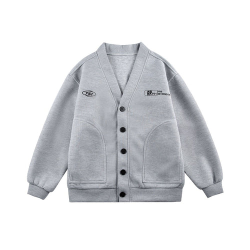 Unisex Boxy-Strickjacke im Waffelstrick mit V-Kragen, durchgehender Knopfleiste und aufgesetzten Rundtaschen Shop Nory
