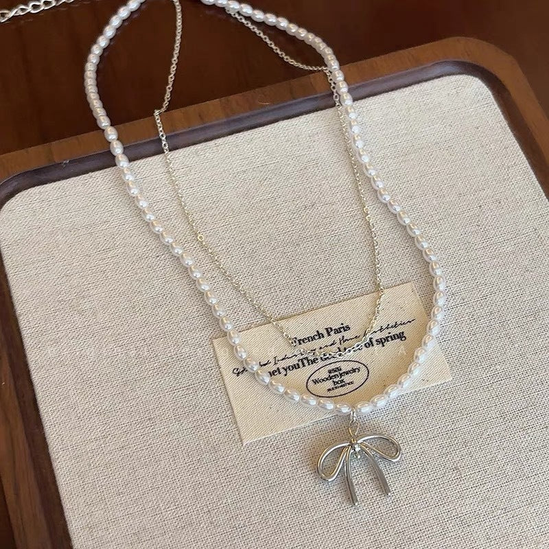 Damen Halskette mit luxuriösen Perlen und filigranem Schleifenanhänger Shop Nory