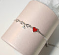 Damen Armband mit herzförmigen Anhängern und funkelnden Kristallelementen Shop Nory