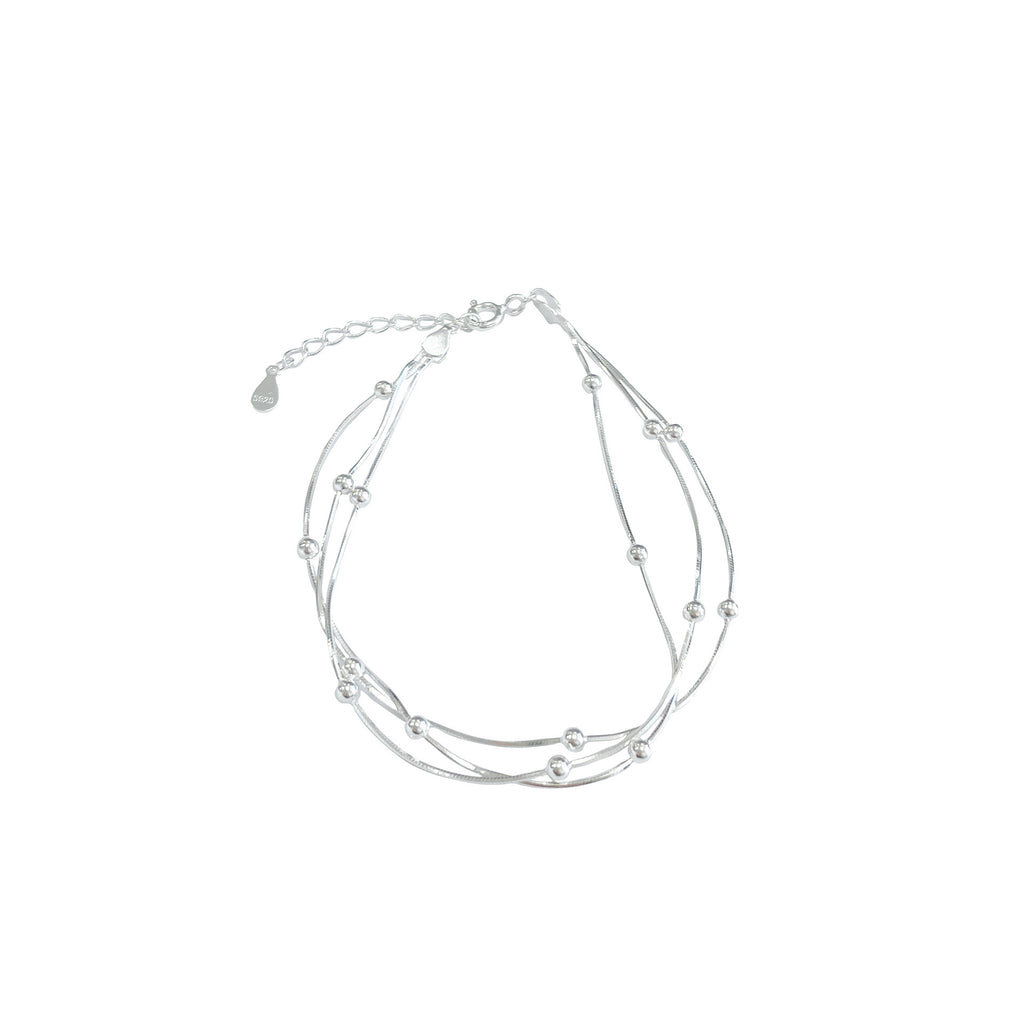 Damen stilvolles Armband mit geschwungenem Design und glänzenden Perlen Shop Nory