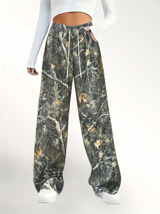 Damen Weite Palazzo-Loungehose im Camouflage-Blattmuster mit Elastikbund, Tunnelzug und Eingrifftaschen Shop Nory