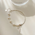 Damen Schmuckarmband mit filigranem Schleifenanhänger und hochwertigen Perlen Shop Nory