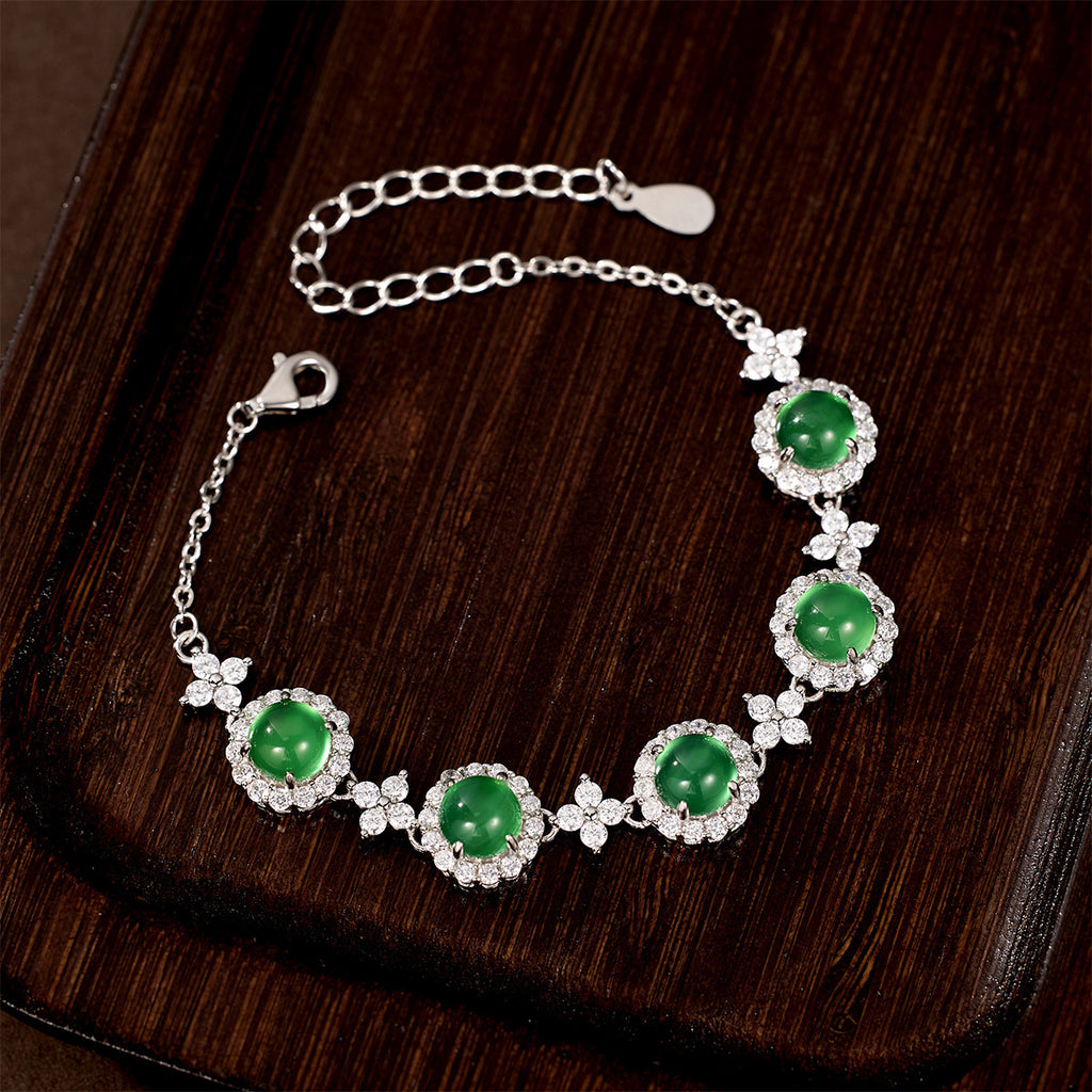 Damen Armband mit funkelnden Kristallen und grünem Edelstein Shop Nory