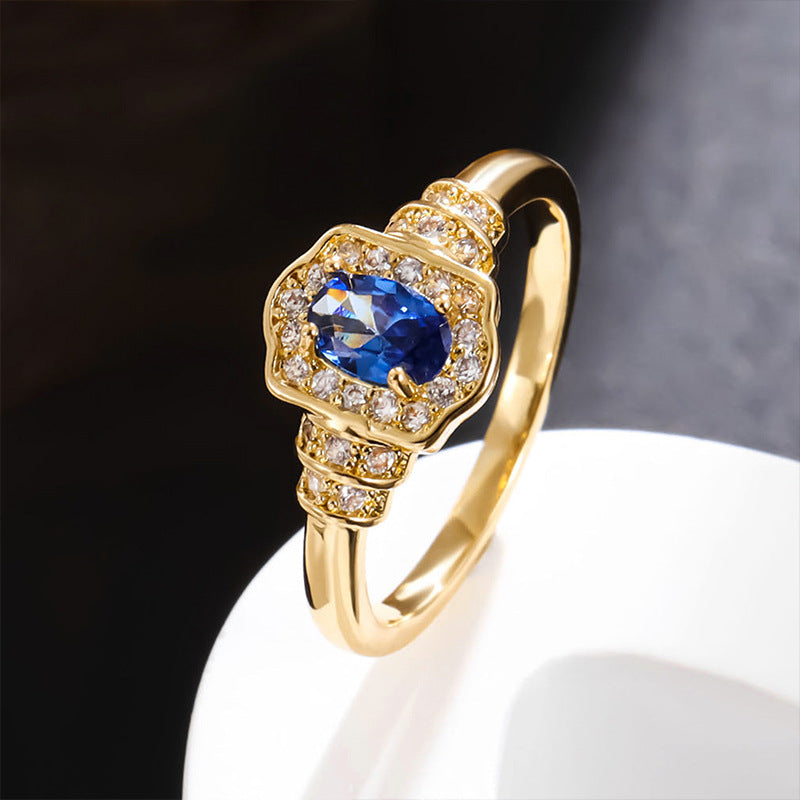 Damenring mit ovalem blauem Edelstein und funkelnden Zirkonia-Steinen Shop Nory
