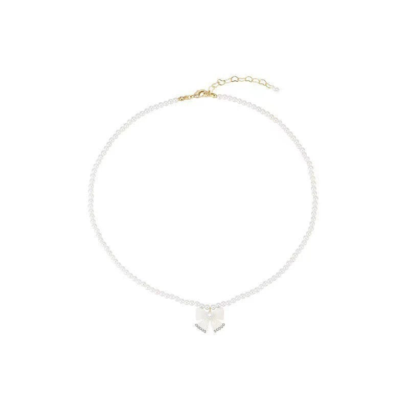 Damen Halskette mit elegantem Perlenband und filigranem Schleifenanhänger Shop Nory