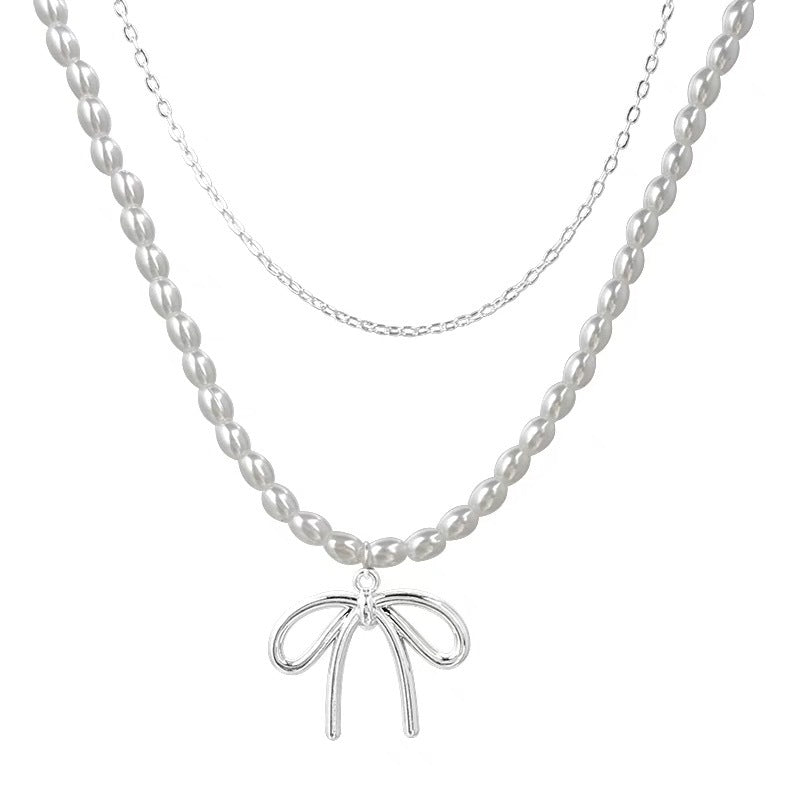 Damen Halskette mit luxuriösen Perlen und filigranem Schleifenanhänger Shop Nory