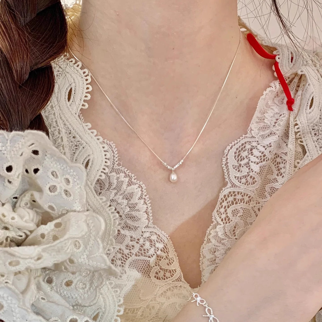 Damen Halskette mit zartem Perlenanhänger und exquisiten silbernen Details Shop Nory