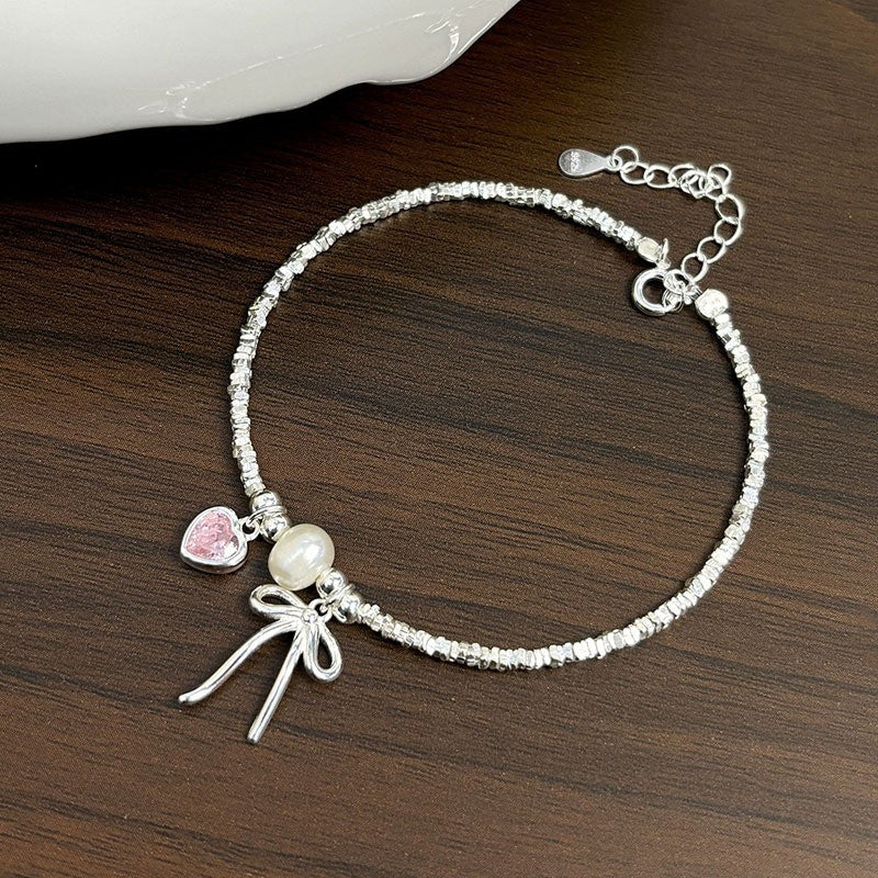 Damen Armreif mit Herz-, Perlen- und Schleifenanhänger Shop Nory