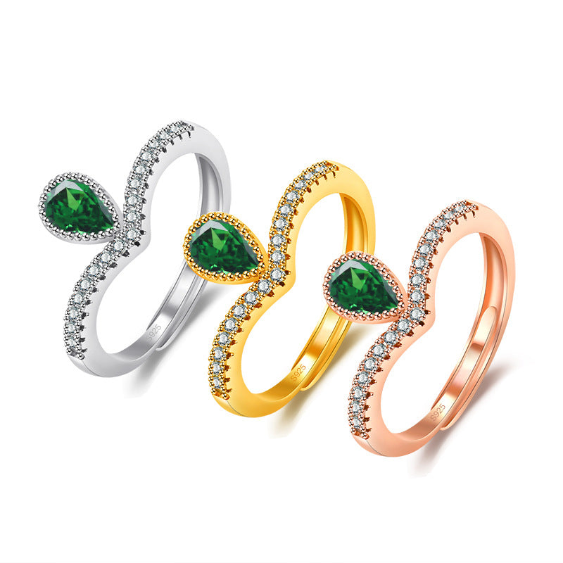 Damenring mit tropfenförmigem grünem Edelstein und Zirkonia-Besatz Shop Nory