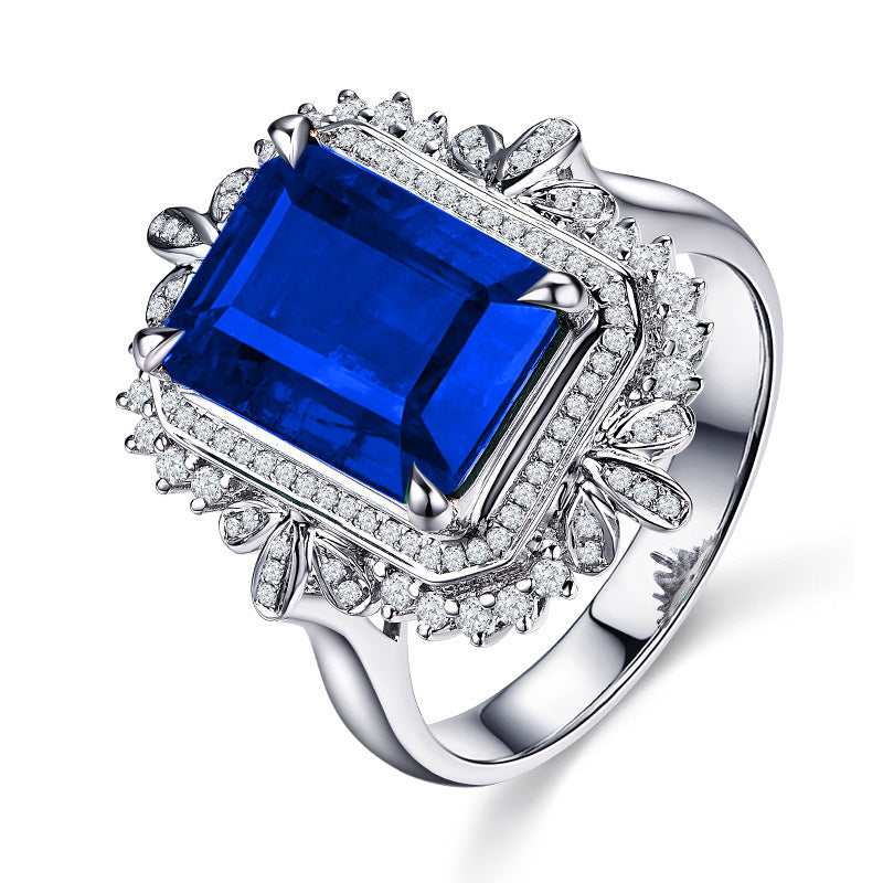 Damenring mit facettiertem blauen Edelstein und kunstvollen Zirkonia-Verzierungen Shop Nory