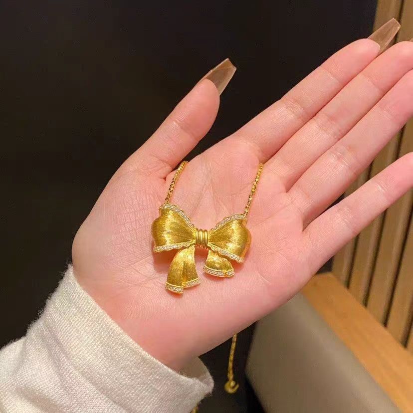 Damen Halskette mit funkelndem Schleifenanhänger Shop Nory